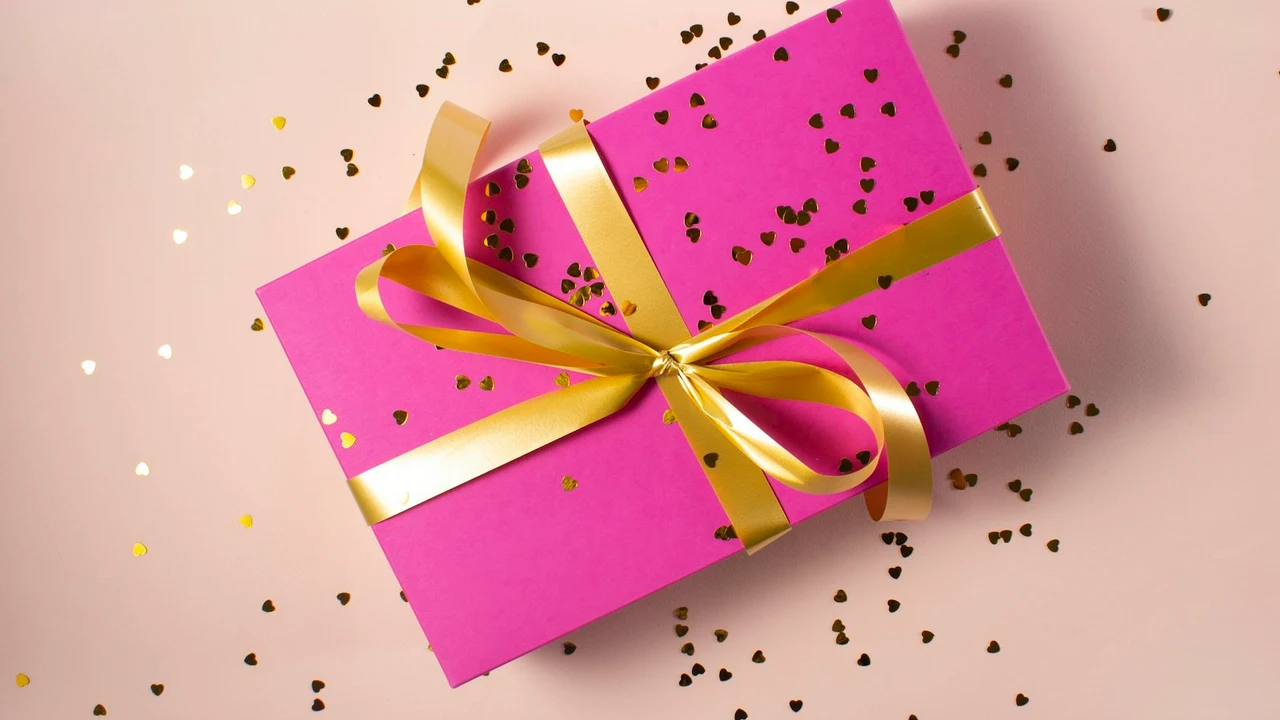 A celebratory birthday gift surprise with balloons and confetti